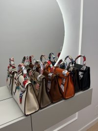 Colorful Hermes Kelly Mini bags displayed in a row.
