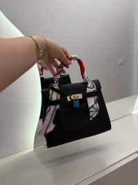 Black Hermes Kelly Mini handbag with colorful handle scarf.