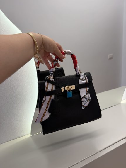 Black Hermes Kelly Mini handbag with colorful handle scarf.