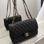 Classic Chanel women's handbag with quilted design and gold chain strap.