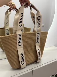Chloe woven beach bag with elegant branded straps on display.