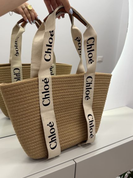 Chloe woven beach bag with elegant branded straps on display.