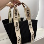 Chloe woven beach bag with elegant black design and branded straps.