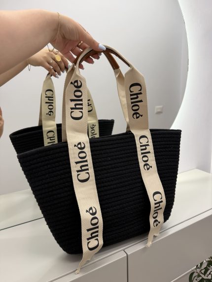 Chloe woven beach bag with elegant black design and branded straps.