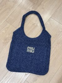 Miu Miu beach bag, blue textured fabric, elegant and comfortable.