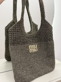 Miu Miu beach bag, elegant textured design, mirror reflection.