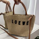 Loewe beach bag with leather handles and woven texture elegance.