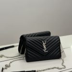 Elegant black YSL women's handbag with chain strap on display.