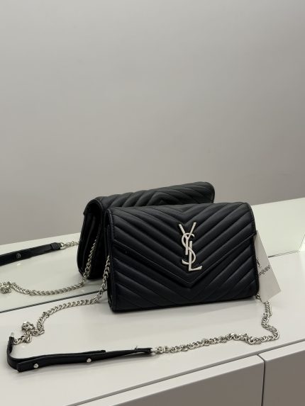 Elegant black YSL women's handbag with chain strap on display.