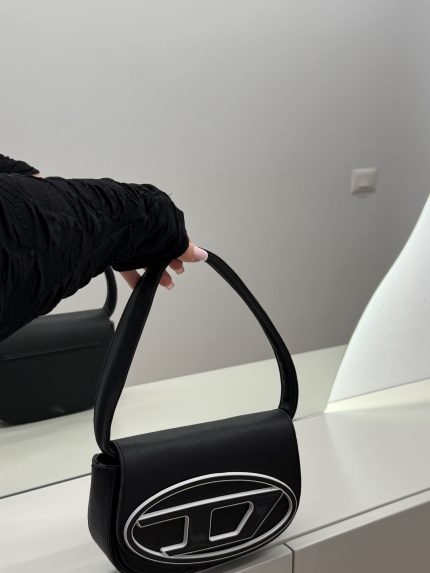 Black Diesel women's handbag with logo, stylish and modern design.