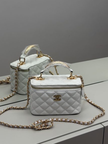 White quilted Chanel vanity bag with gold chain for women.