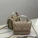 Beige Chanel Flap Bag with gold chain and logo.