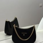 Michael Kors Jet Set black bag with gold chain detail.