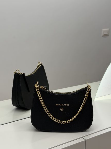 Michael Kors Jet Set black bag with gold chain detail.