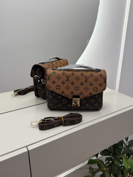 Louis Vuitton Pochette Metis handbag on mirrored surface.