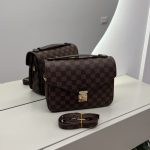 Louis Vuitton Pochette Metis handbag with checkered design on display.