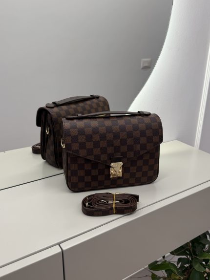 Louis Vuitton Pochette Metis handbag with checkered design on display.