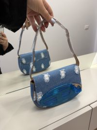 Diesel 1DR blue denim women's bag with distressed design.
