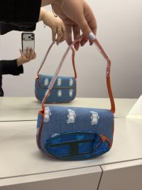 Diesel 1DR denim handbag with orange trim, stylish and functional.