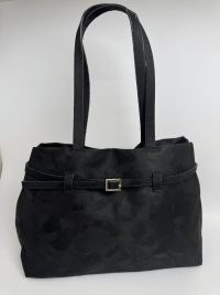 Elegant black suede handbag with strap and buckle detail.