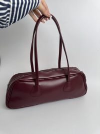 Burgundy women's boxy handbag with zipper and long handles.