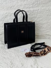 Structured black handbag with leopard print scarf accessory.