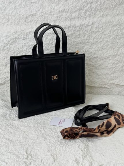 Structured black handbag with leopard print scarf accessory.