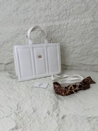 Structured white handbag with leopard print scarf accessory.
