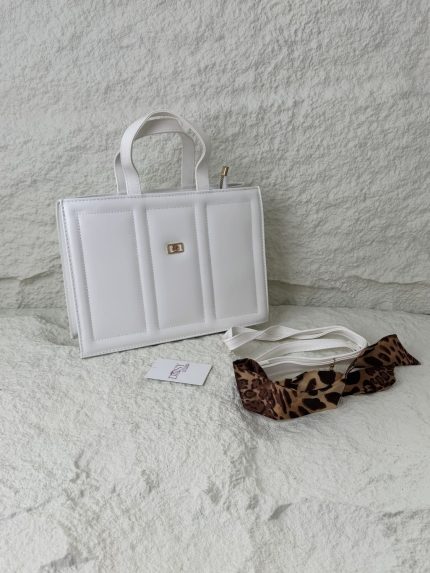 Structured white handbag with leopard print scarf accessory.