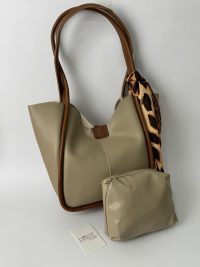 Elegant women's bucket bag with scarf and pouch, beige and brown accents.