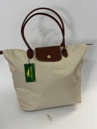 Çanta Longchamp Le Pliage XL cream tote with brown leather handles.