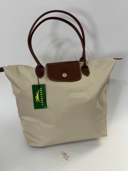 Çanta Longchamp Le Pliage XL cream tote with brown leather handles.