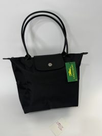 Black Longchamp Le Pliage XL tote bag with handles.
