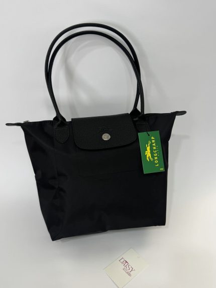 Black Longchamp Le Pliage XL tote bag with handles.