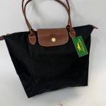 Black Longchamp Le Pliage XL tote bag with brown handles.