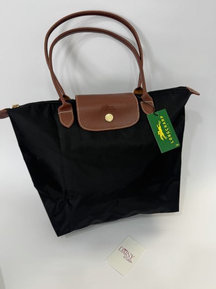 Black Longchamp Le Pliage XL tote bag with brown handles.