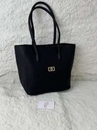 Elegant black university tote bag from Daisy Store on textured background.