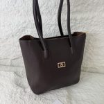 Brown leather university bag with handles, Daisy Store tag visible.