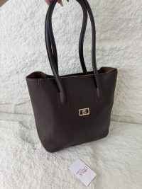 Brown leather university bag with handles, Daisy Store tag visible.