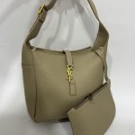 Elegant beige tote bag with matching pouch and gold accents.
