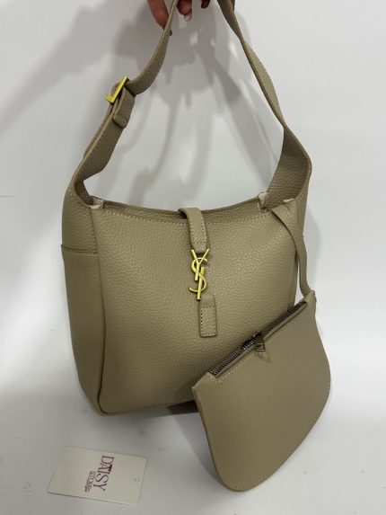 Elegant beige tote bag with matching pouch and gold accents.