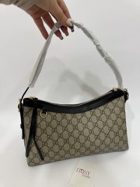 Stylish university bucket bag with patterned design and black accents.
