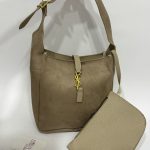 Beige bucket bag with gold accents and detachable pouch.