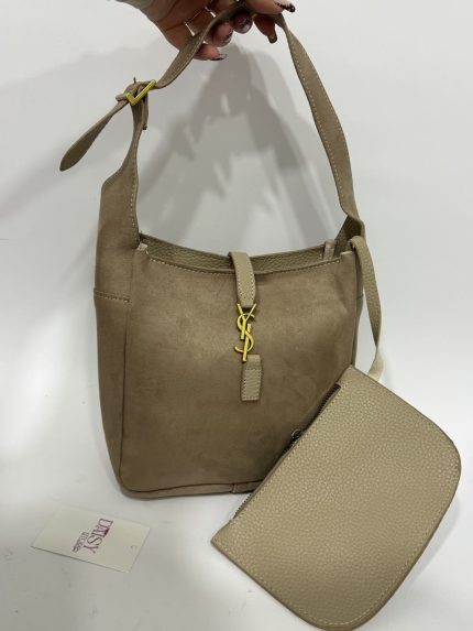 Beige bucket bag with gold accents and detachable pouch.