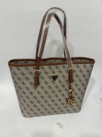 Çanta bucket me shall II nga Daisy Store, patterned handbag with brown handles.