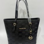Black Michael Kors tote bag with embossed logo design.
