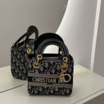Christian Dior small handbag, elegant black and gold design.