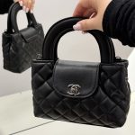 Black quilted Chanel mini handbag with elegant design.