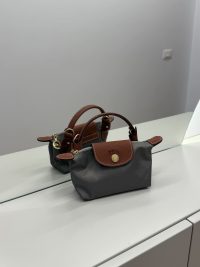Longchamp Le Pliage XS handbag in gray with brown leather accents.