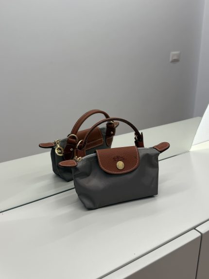 Longchamp Le Pliage XS handbag in gray with brown leather accents.